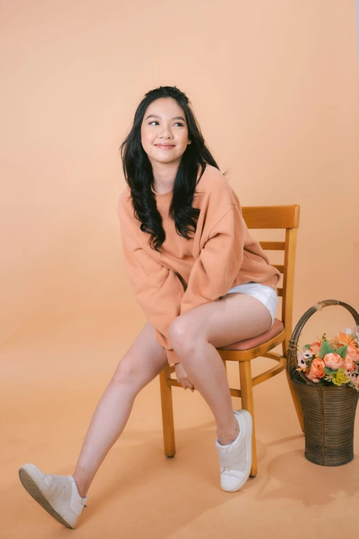 a woman sitting on a chair with her legs crossed