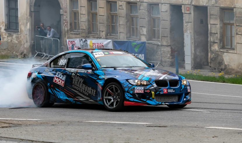 a blue bmw sports car with smoke coming out