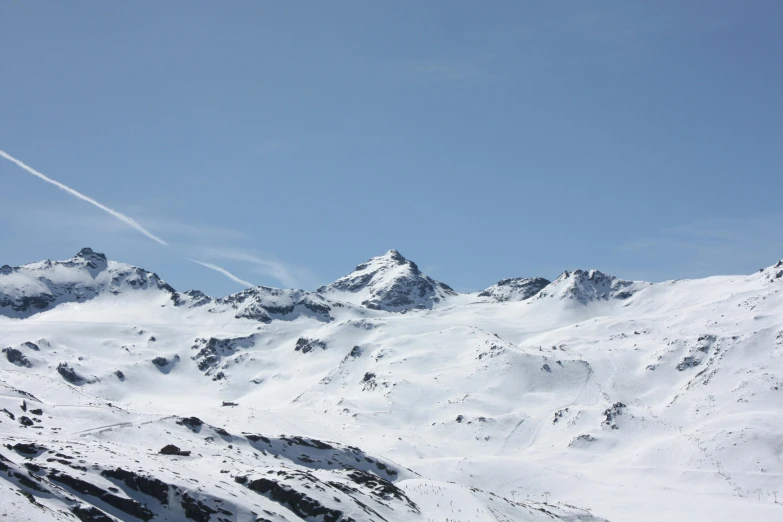 some very tall mountain covered in snow with white writing on it