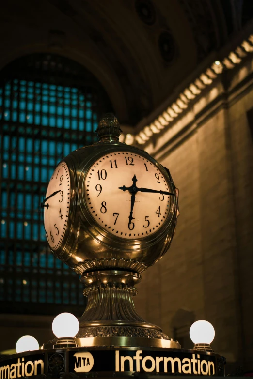 this is an elaborate golden globe with three clocks on each side