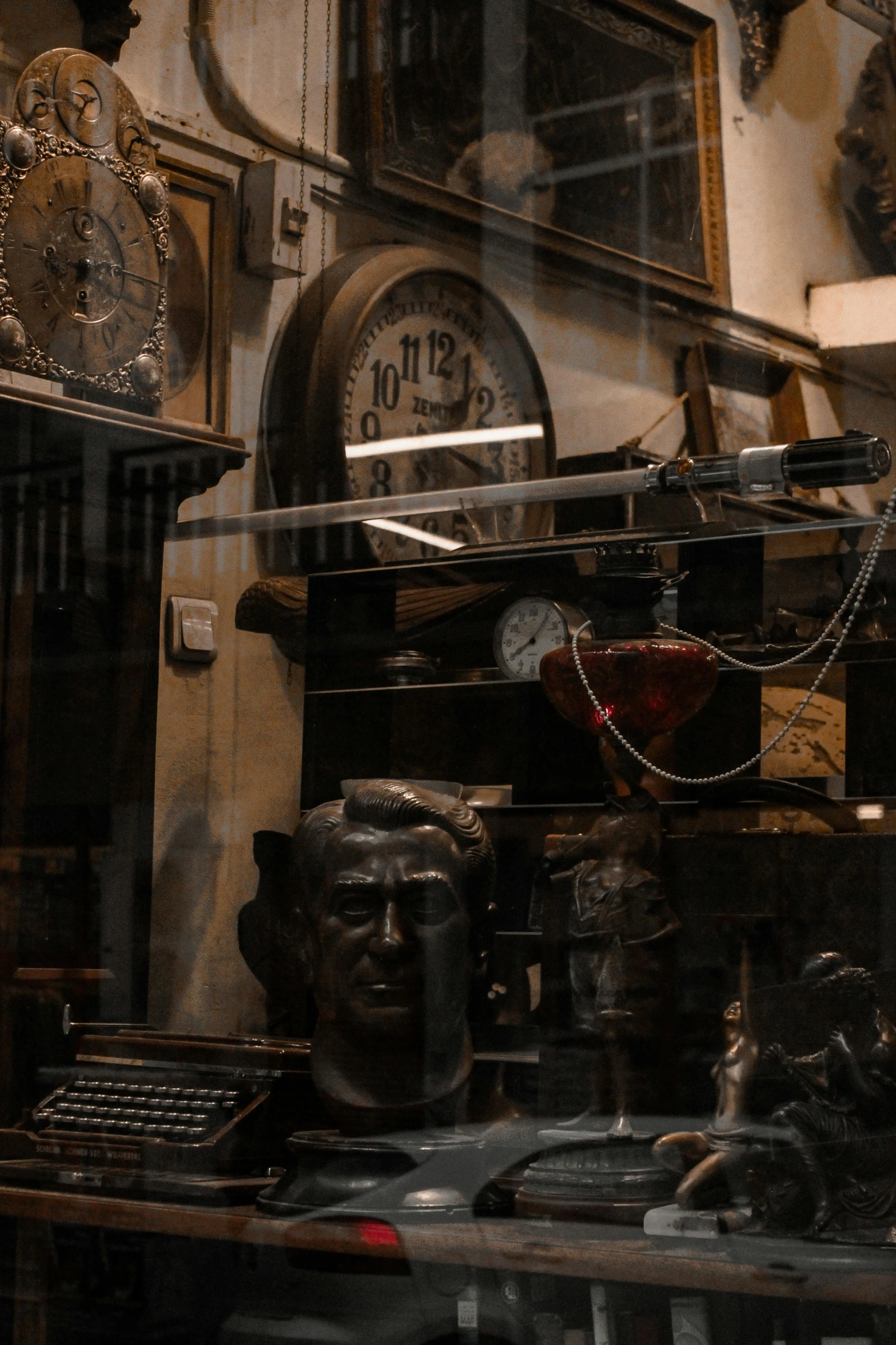 a view through a glass of a bust of a man