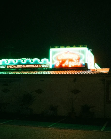 an illuminated building with a elephant on the roof