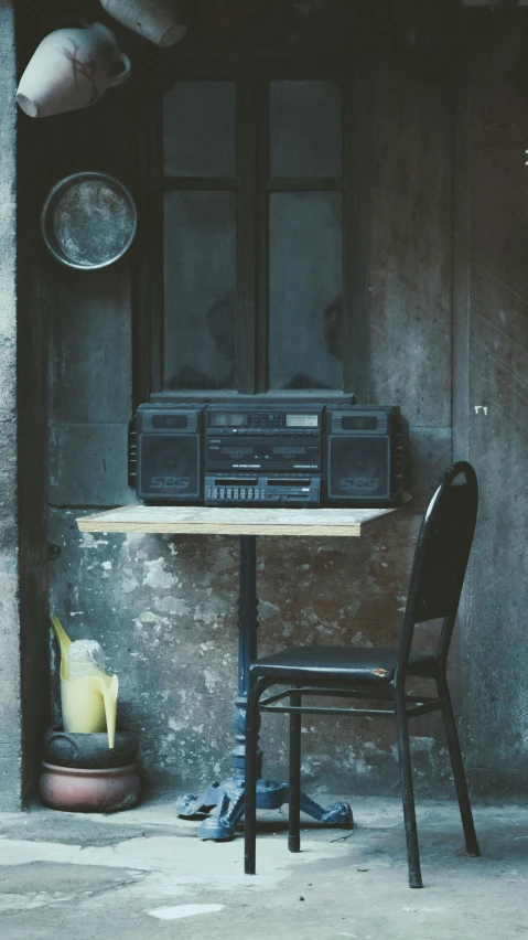 a table with a radio and a chair on it