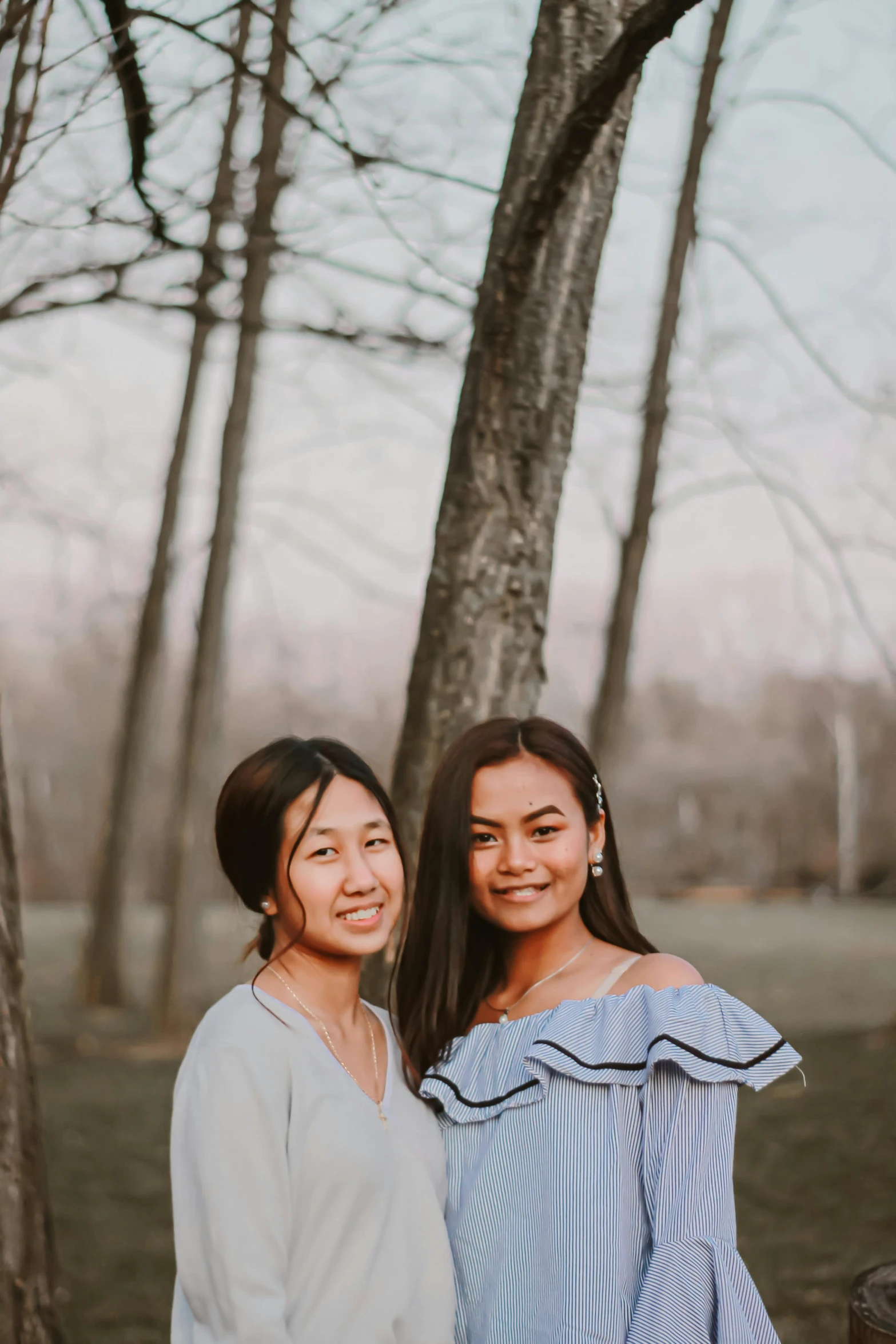 two women posing for the camera, and smiling at the camera