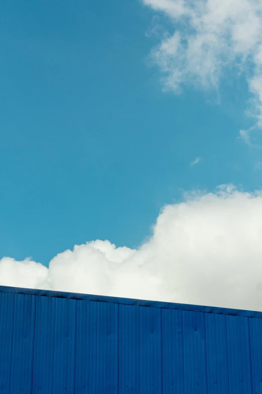 an airplane is flying through the sky over the building