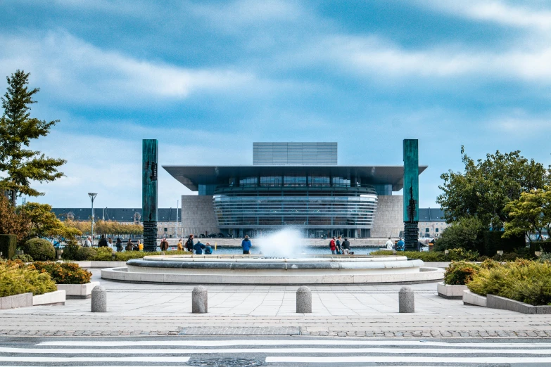 a park area with fountain and people around