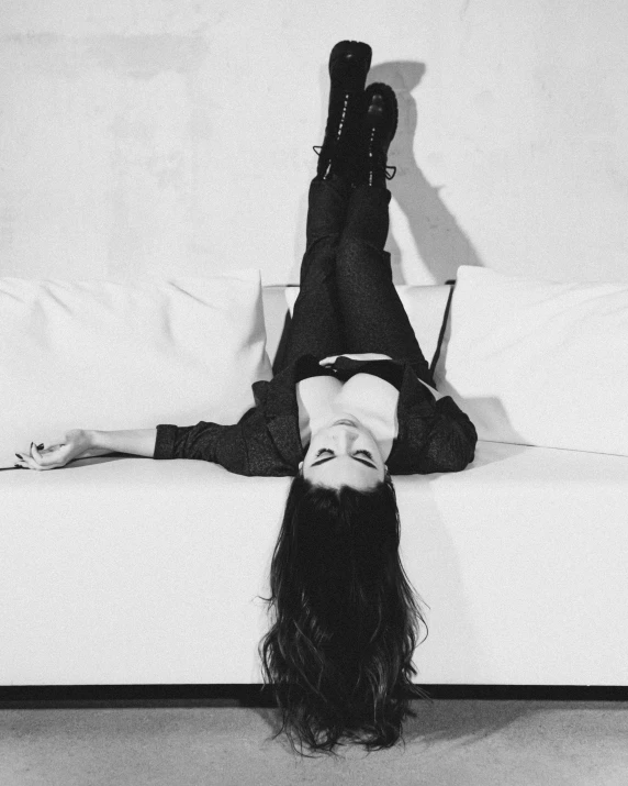 a woman laying on top of a bed with long hair