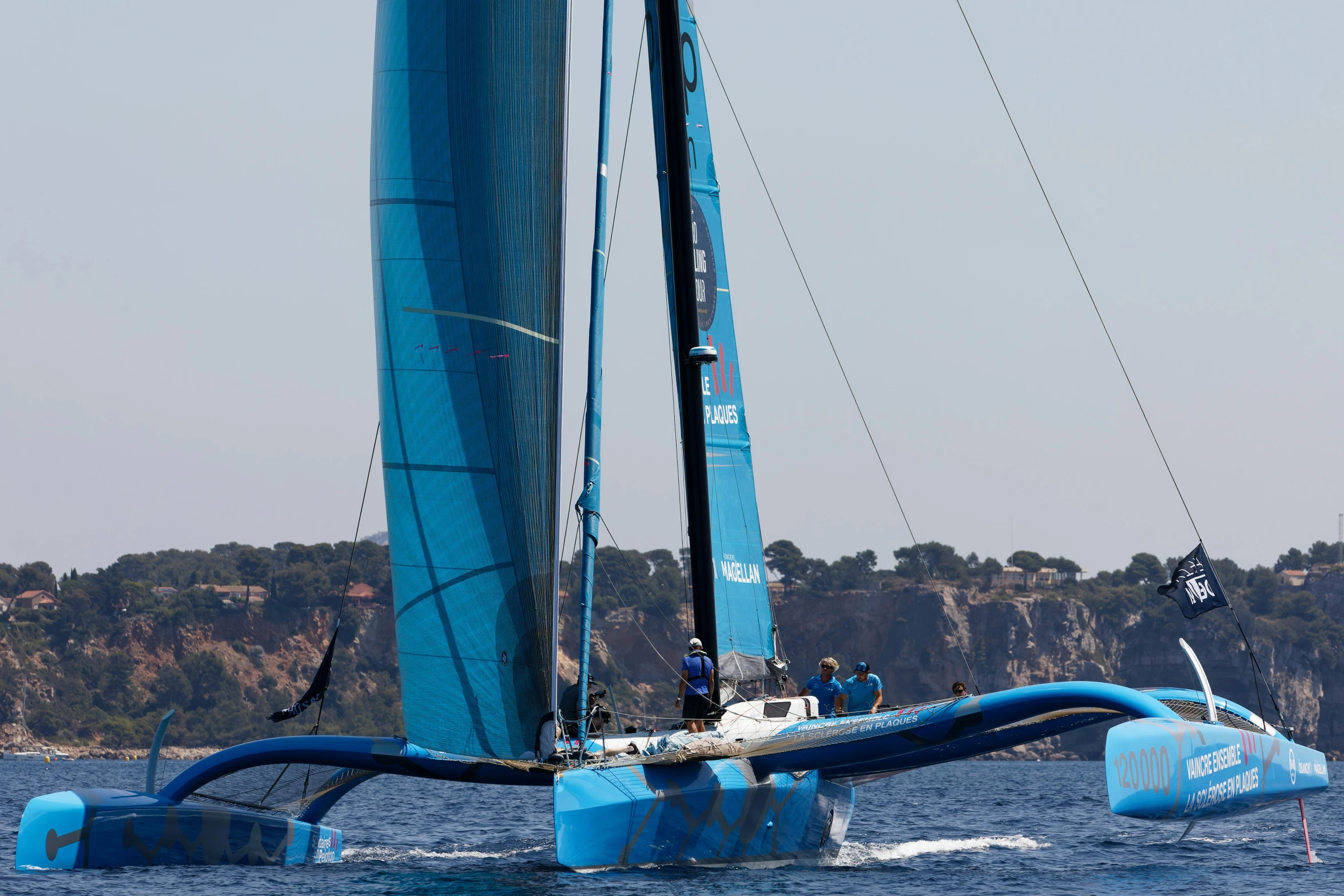 a sailboat is in the water and is making its way around an obstacle