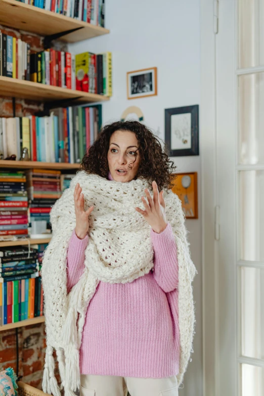 a woman in a pink sweater posing for the camera