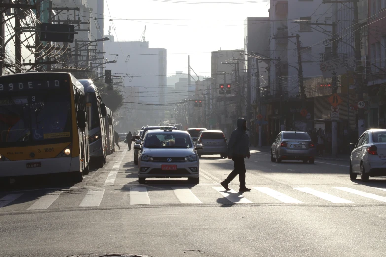 vehicles driving down the street near a busy intersection