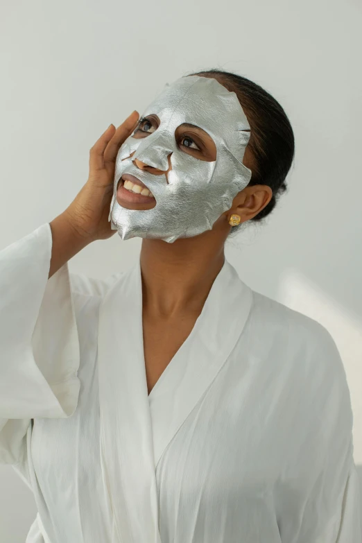 a woman is wearing a mask made of tinfoil