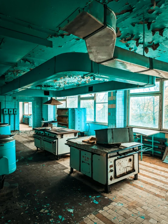 a very run down and filthy kitchen with broken windows