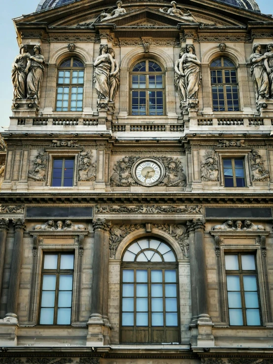 an ornate building with two large windows on each side of it