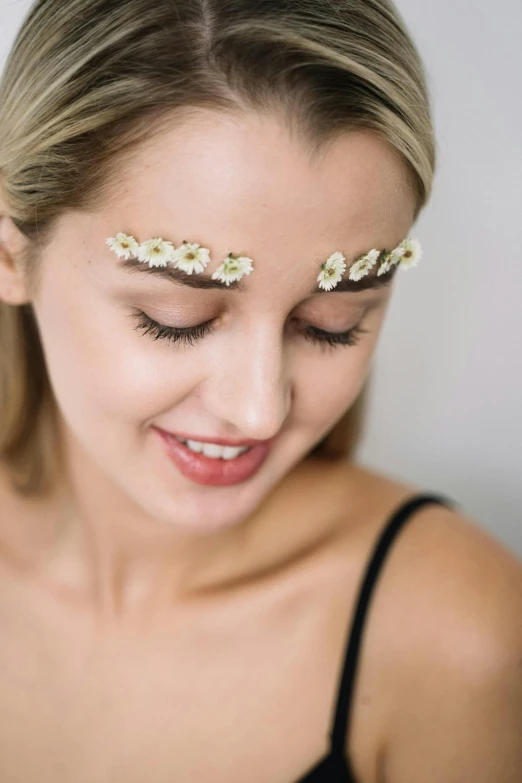 a woman with two white flowers in her hair