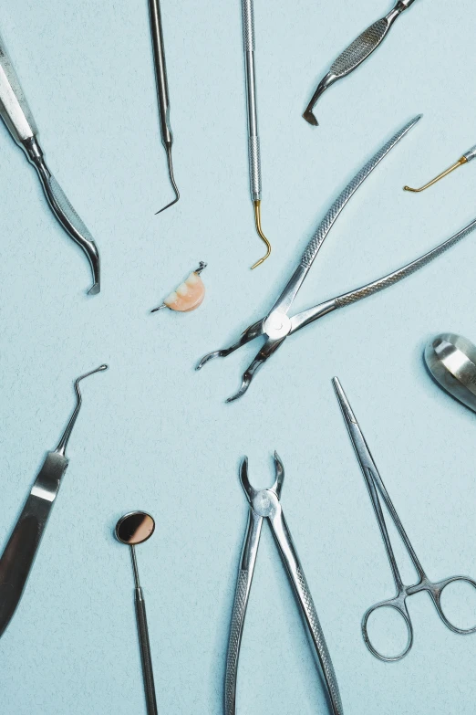 an assortment of dental tools and medical utensils arranged on a counter