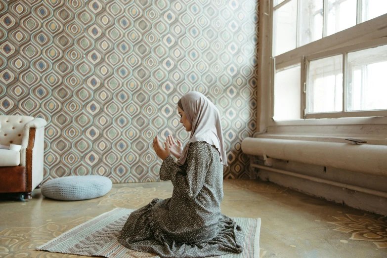 an image of a person kneeling on a rug