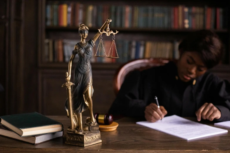 a woman writing in her book on a desk