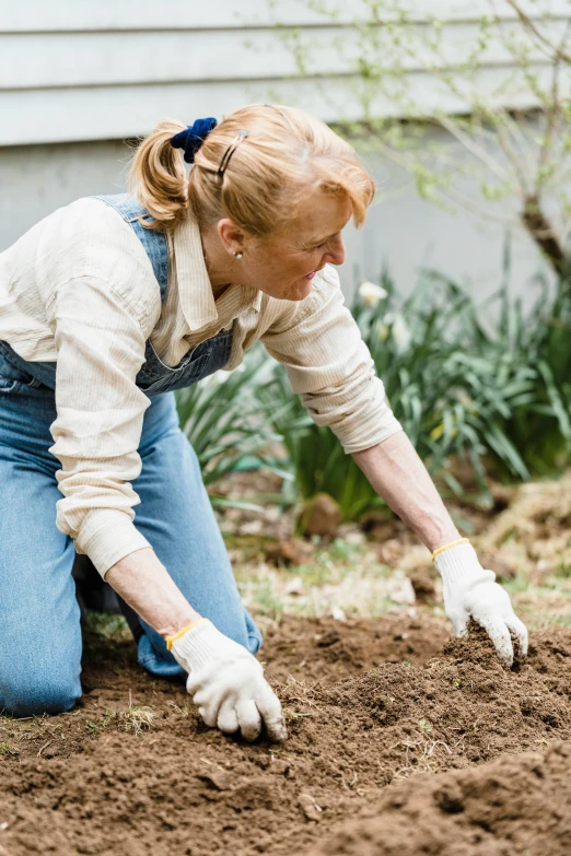 a woman in her twenties digging through dirt