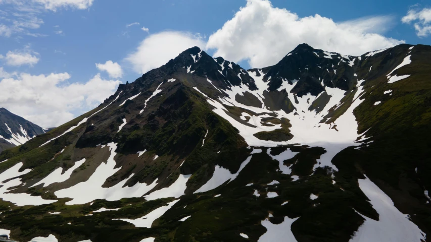 some mountains have snow on them and blue sky