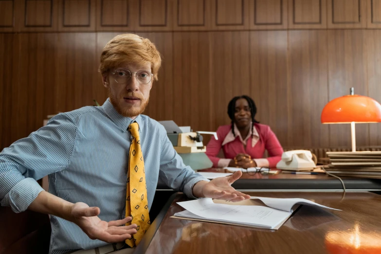 a red headed man wearing a yellow tie