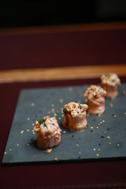 small appetizers are laying on a grey surface