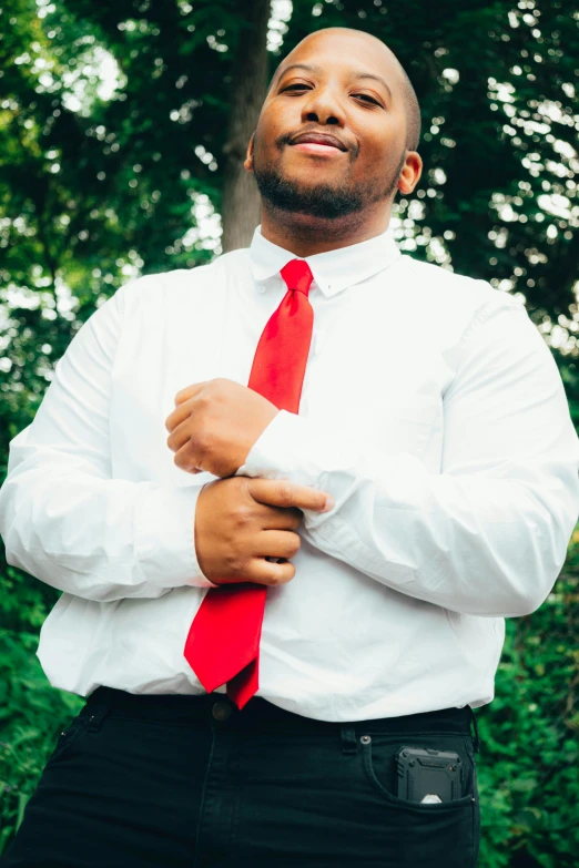 a man wearing a white shirt and a red tie