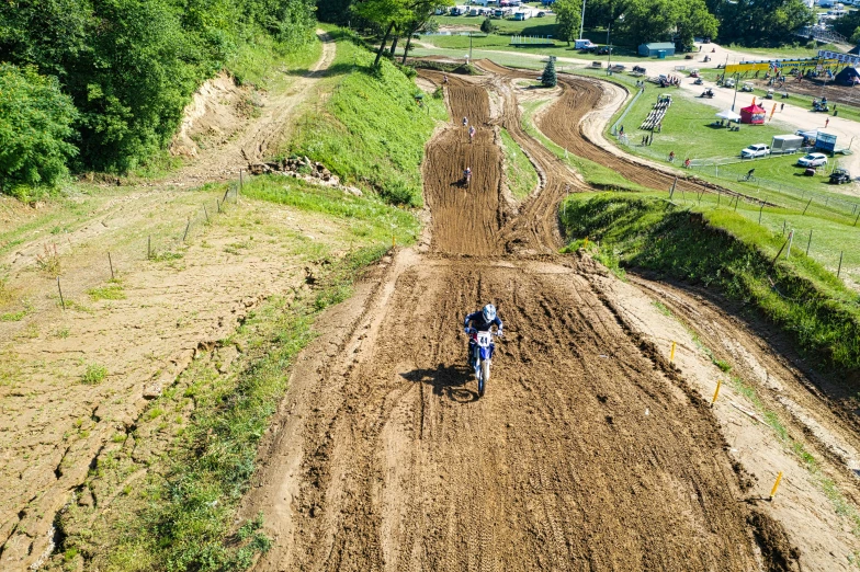 people riding on dirt roads on a sunny day