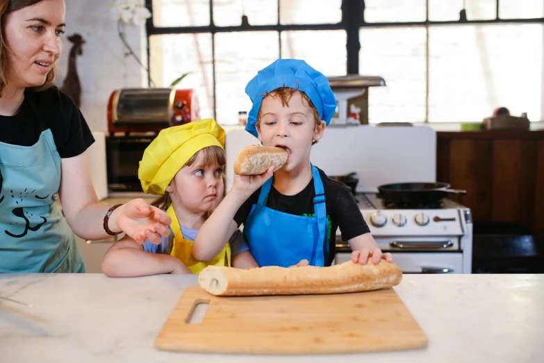 three young children are making donuts together in the kitchen