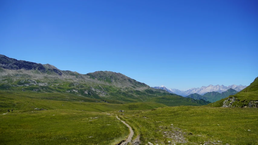 a scenic po shows a path leading through mountains