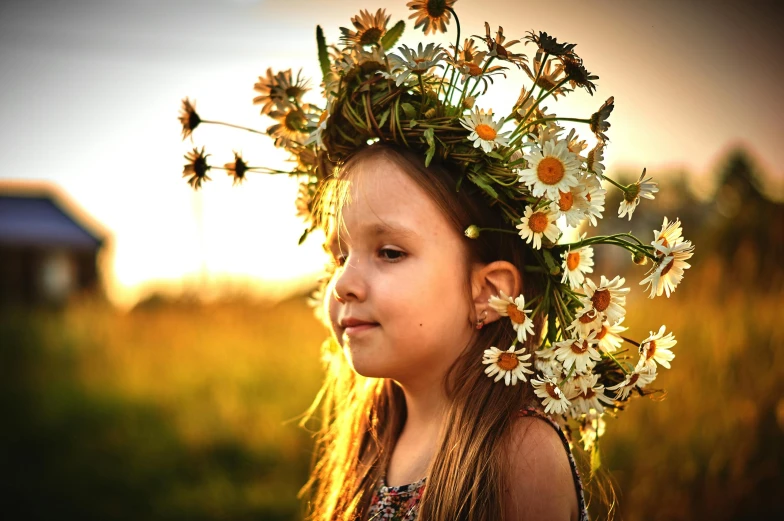 a little girl wearing flowers on her head