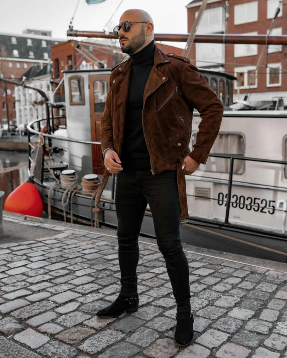 a man standing on brick walk near boat