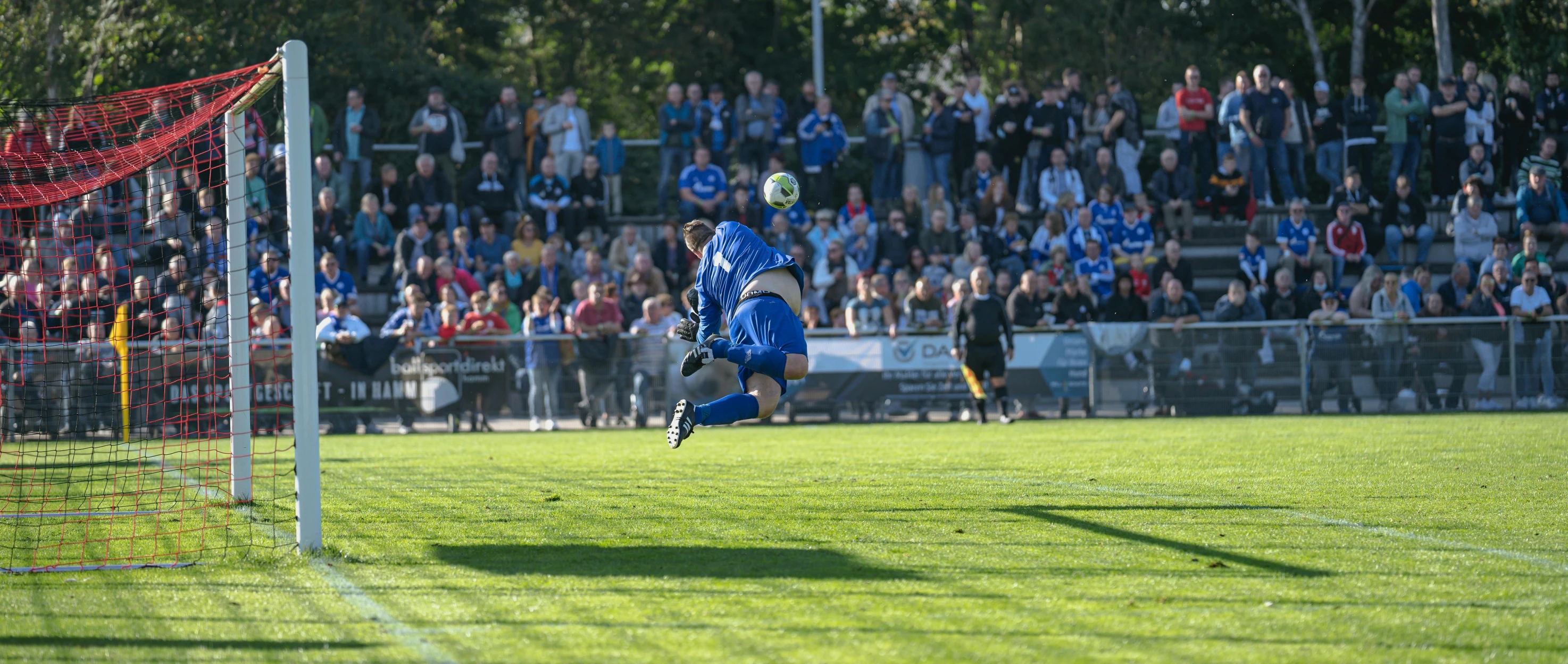 a soccer player reaching up to head the ball