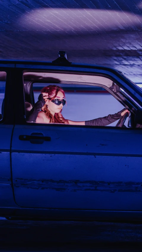 woman in sunglasses in a car during dusk