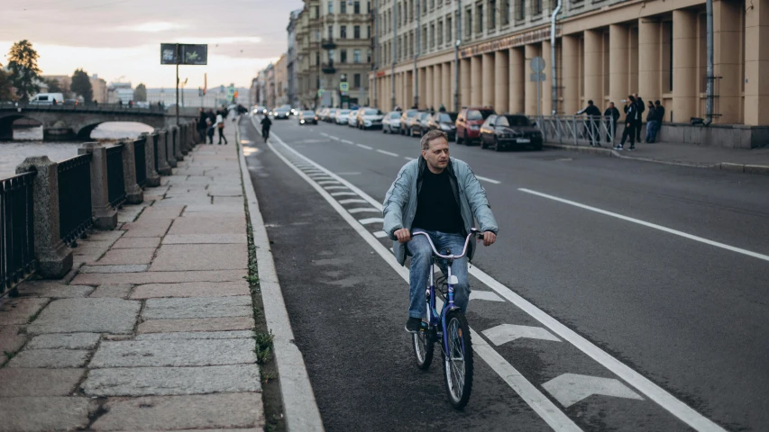 a man riding his bike down the street