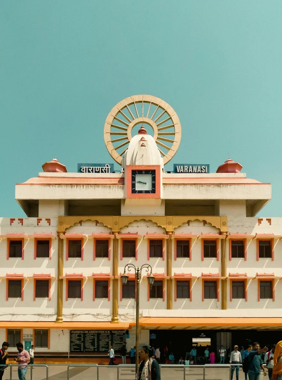 a large white building with people walking by in front of it