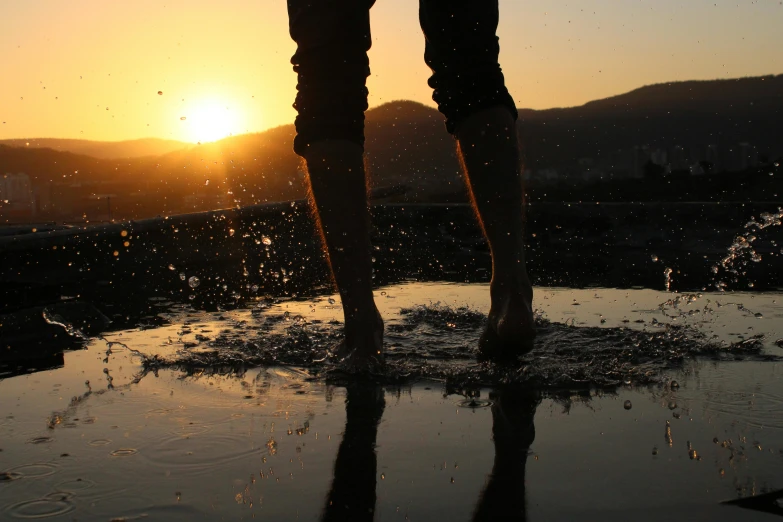 a person is standing in the dle with their legs stretched out