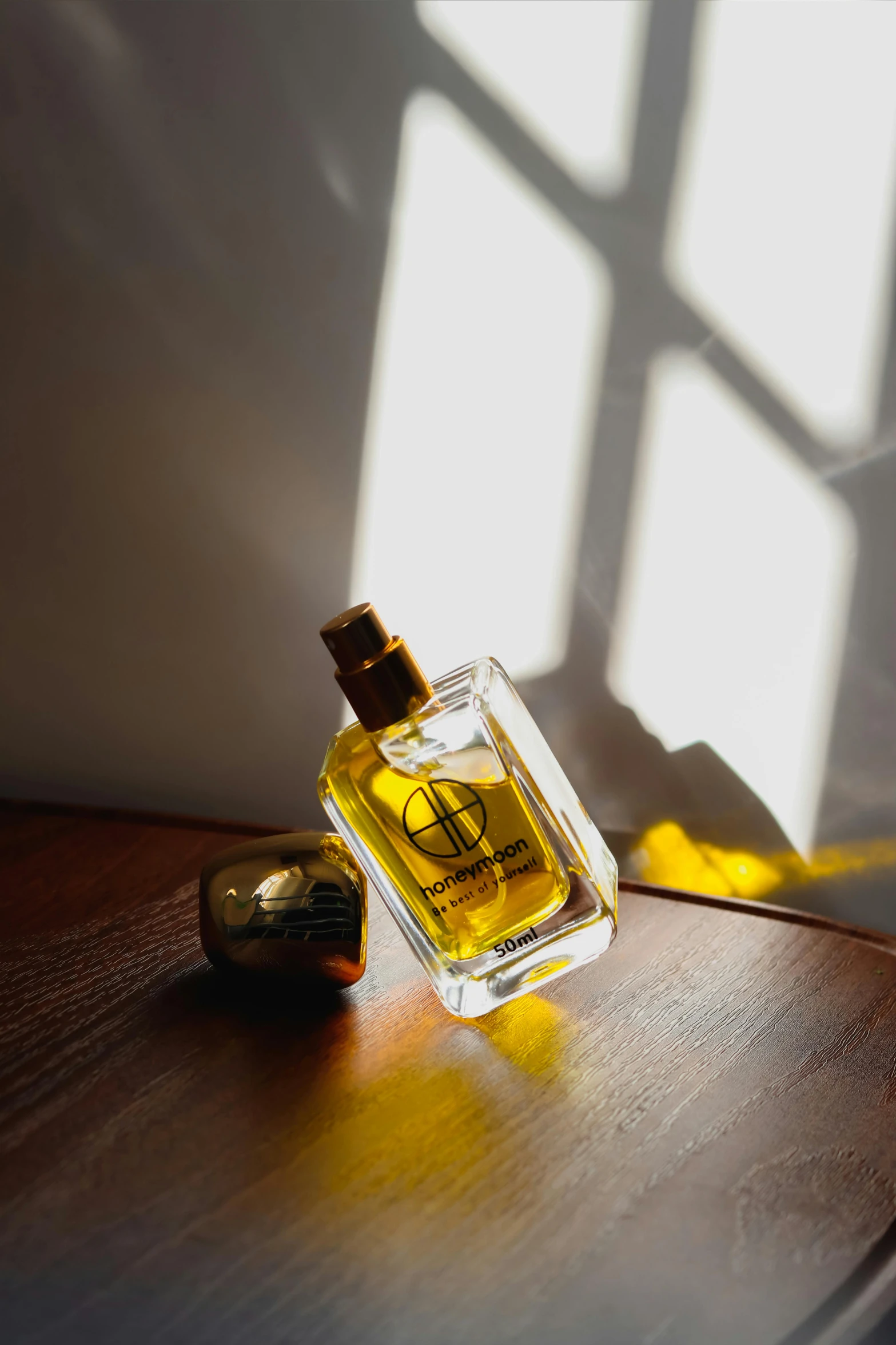 a bottle of perfume sitting on top of a wooden table