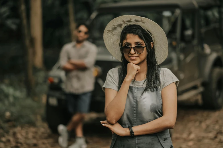 two people standing in the woods near some jeeps