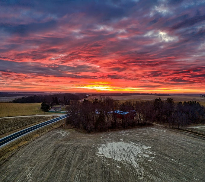 a sunset in the middle of an empty field