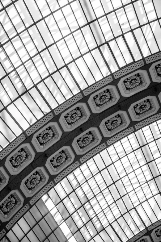 a clock and ornate tile work are seen in a ceiling