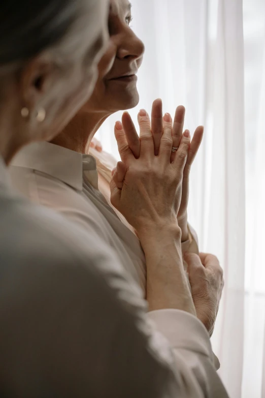 two elderly people are applauding their hands together