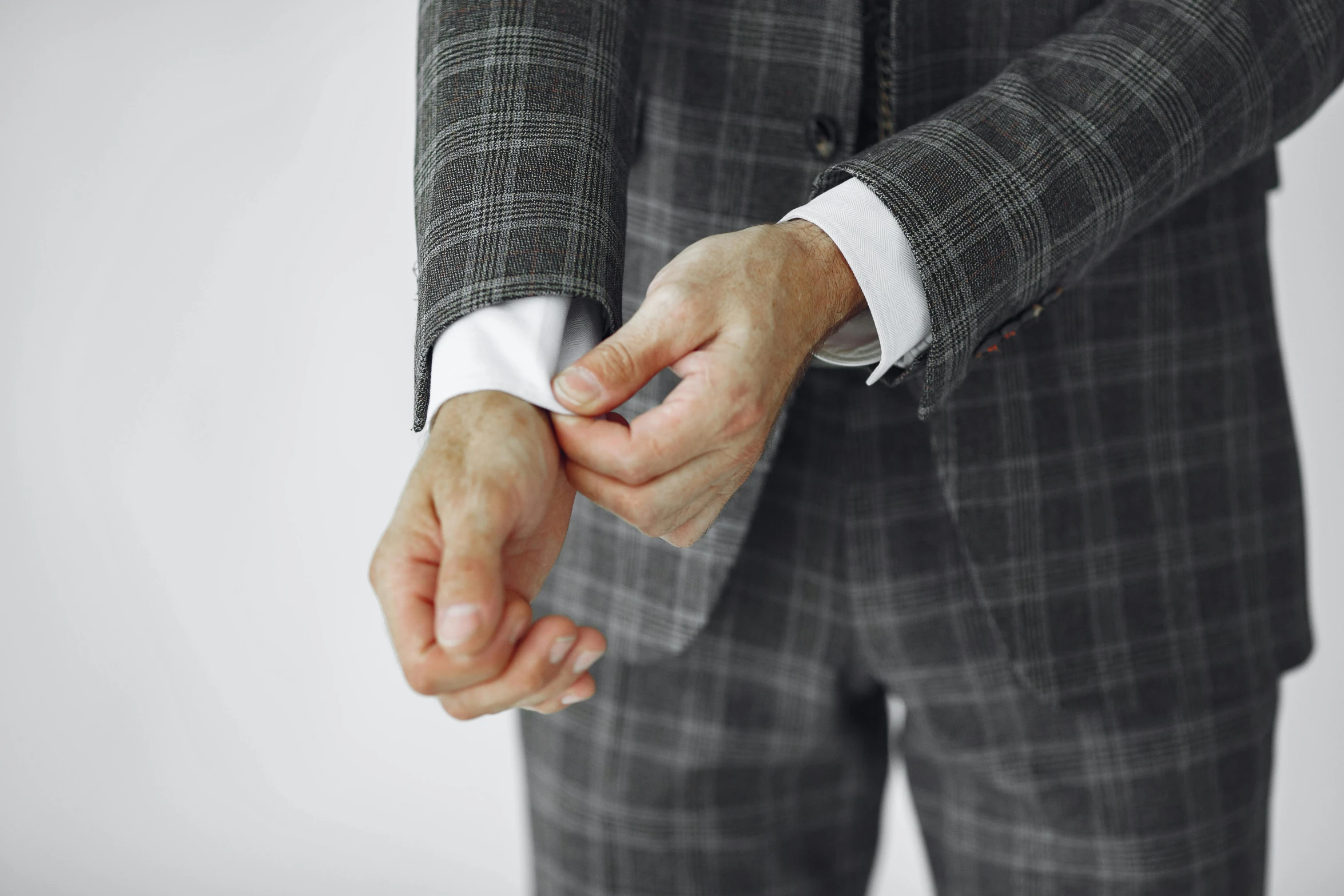 a person in a suit and tie holds hands with each other