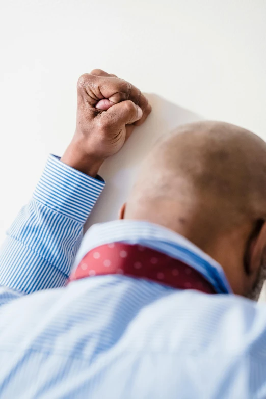 the black man is holding onto the white board