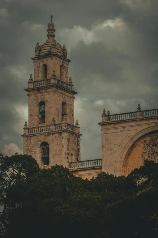 a clock tower is shown against a stormy sky