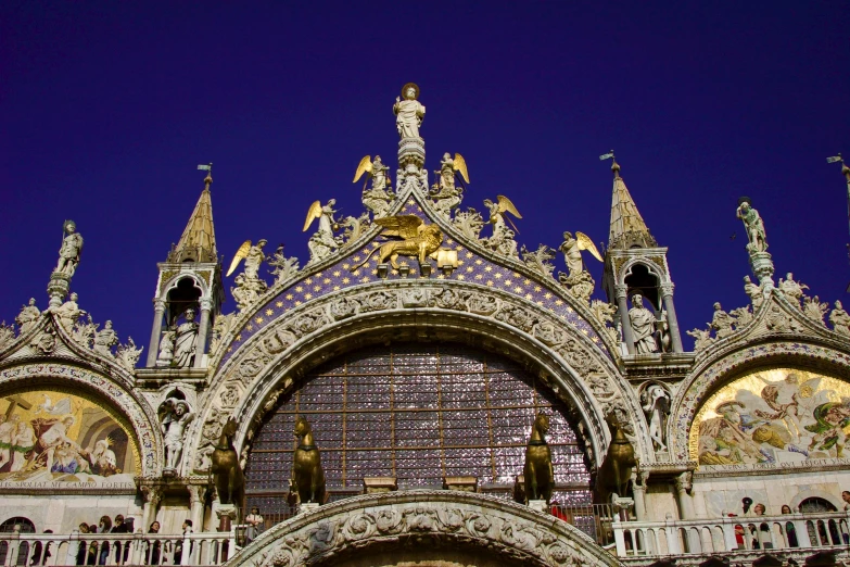 ornate architecture at night with a clock on the front of it