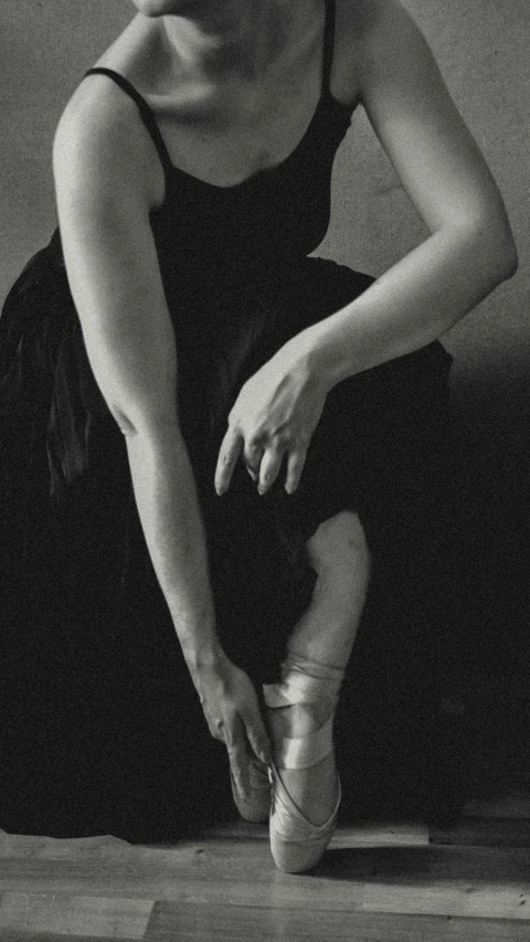 a woman wearing all black knee high ballet shoes