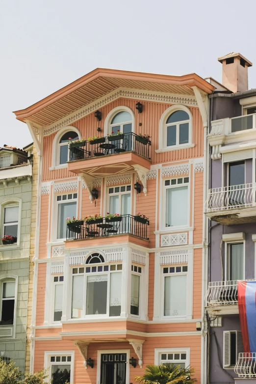 a large peach colored building with balconies and balcony balconies