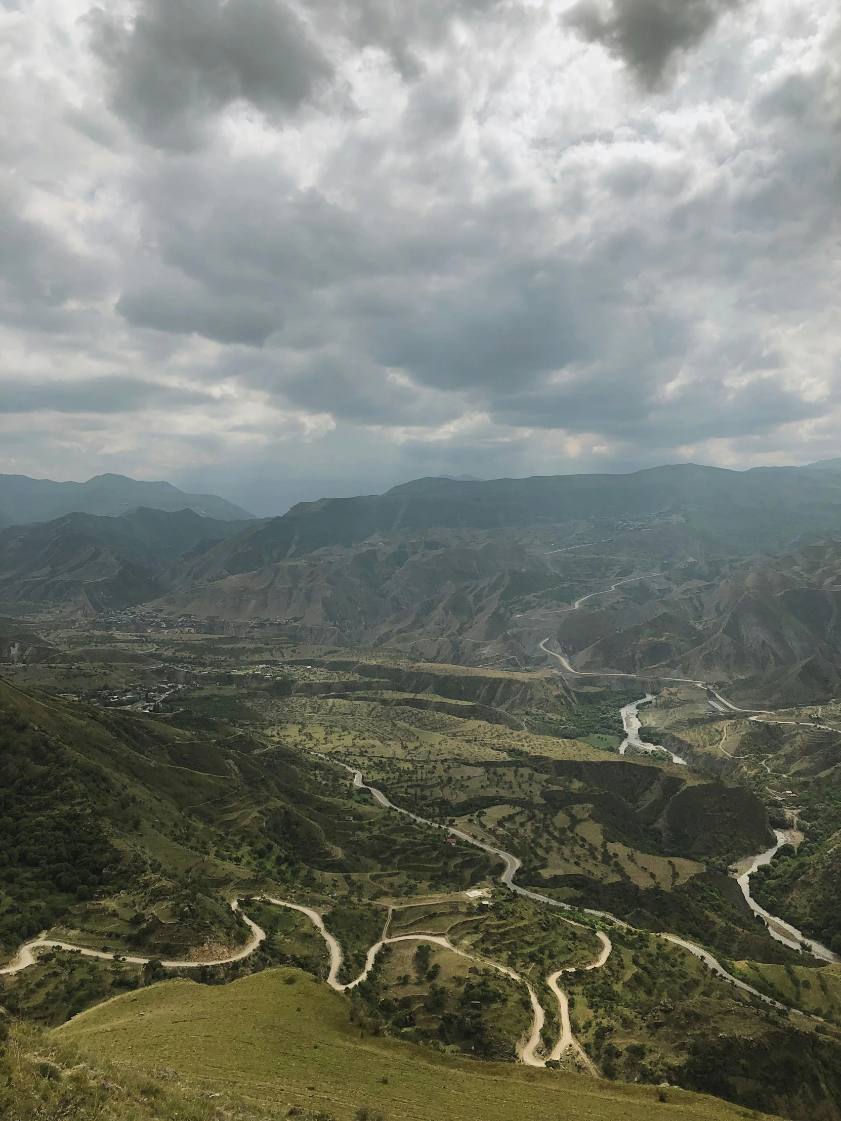 a hilly area with a winding road winding up the side