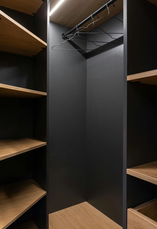 a closet with no shelves and empty wooden shelves