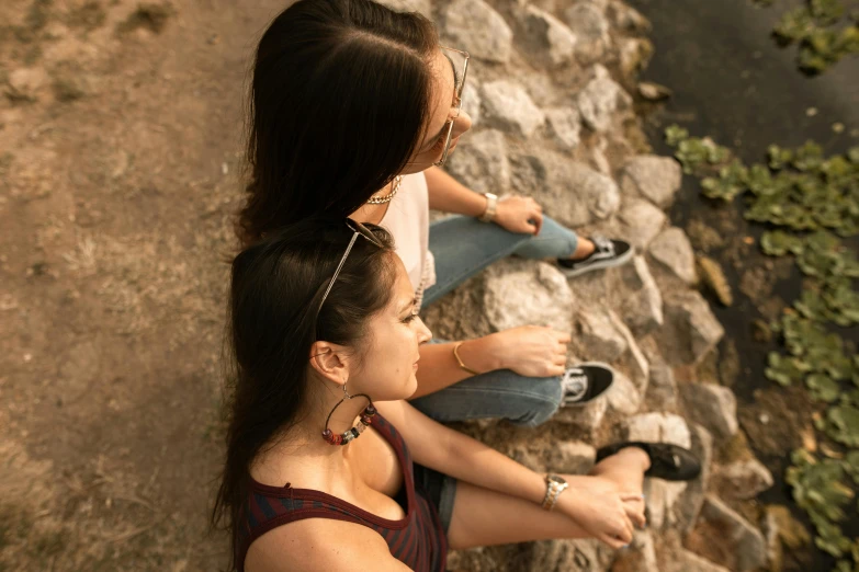 a couple of women standing next to each other on a hill